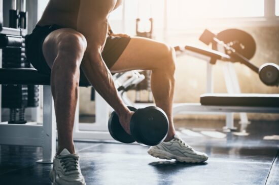 Man exercising by lifting weights.