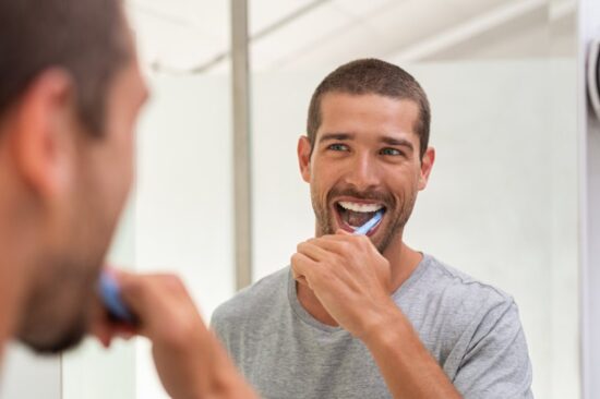 Man brushing his teeth.